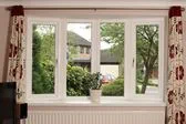 Curved UPVC bay window with double glazing finished in White from the Anglian bay window range