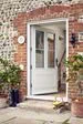 White wooden front door with cottage bars in traditional wide Georgian style with black door handle from the Anglian wooden front doors range