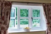 Interior view of traditional white UPVC casement windows with cottage bars and black handles from Anglian Home Improvements