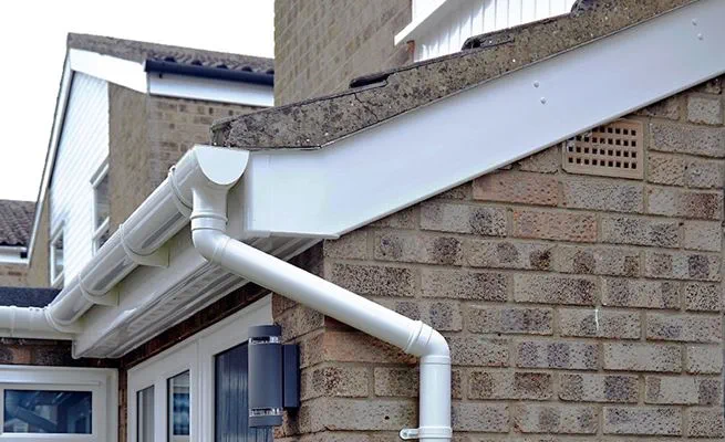 Whole house rooftrim renovation including White uPVC guttering downpipes soffits and fascias