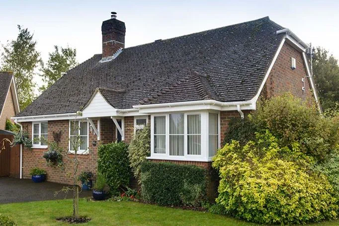 Bungalow with White UPVC bay casement window and roofline guttering and fascia from Anglian Home Improvements