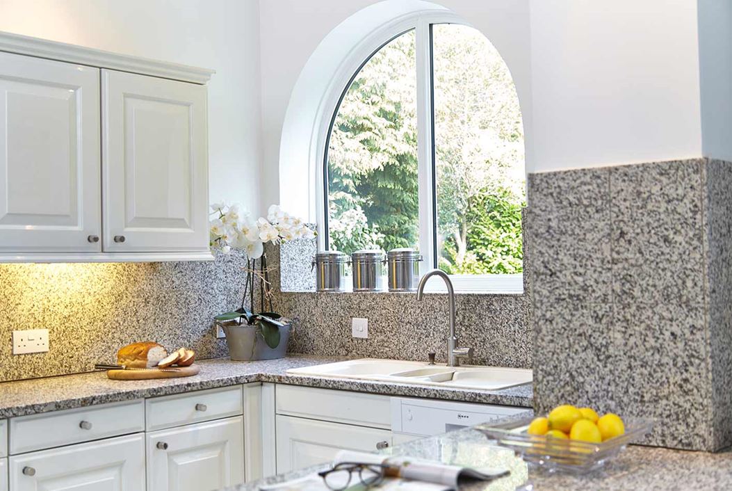 Pair of curved design shaped windows in white uPVC from Anglian Home Improvements