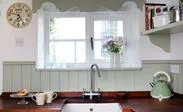 Narrow White cottage UPVC casement kitchen window with black window handle from the Anglian cottage window range